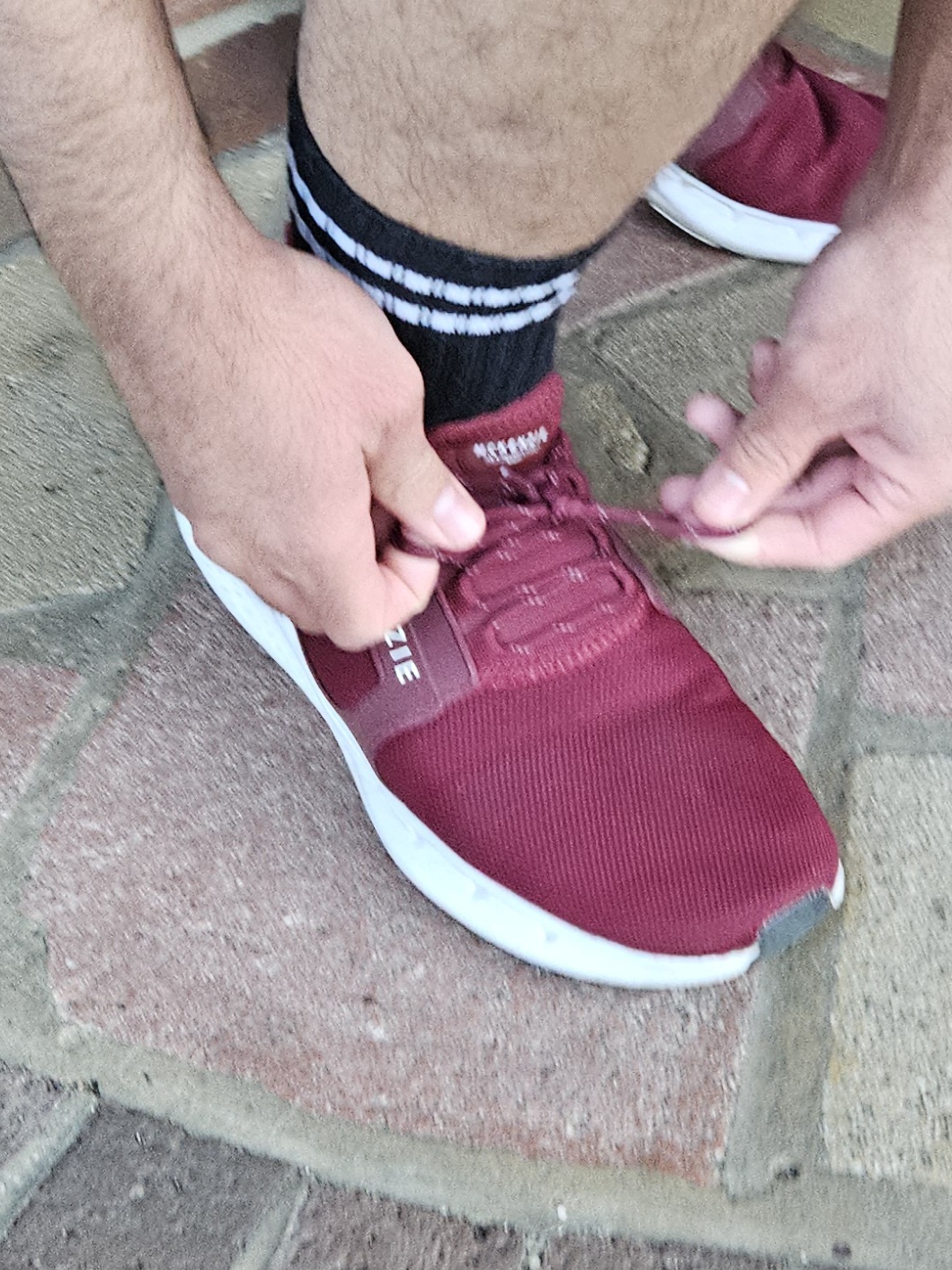 Runner tying up his shoes ready for a run